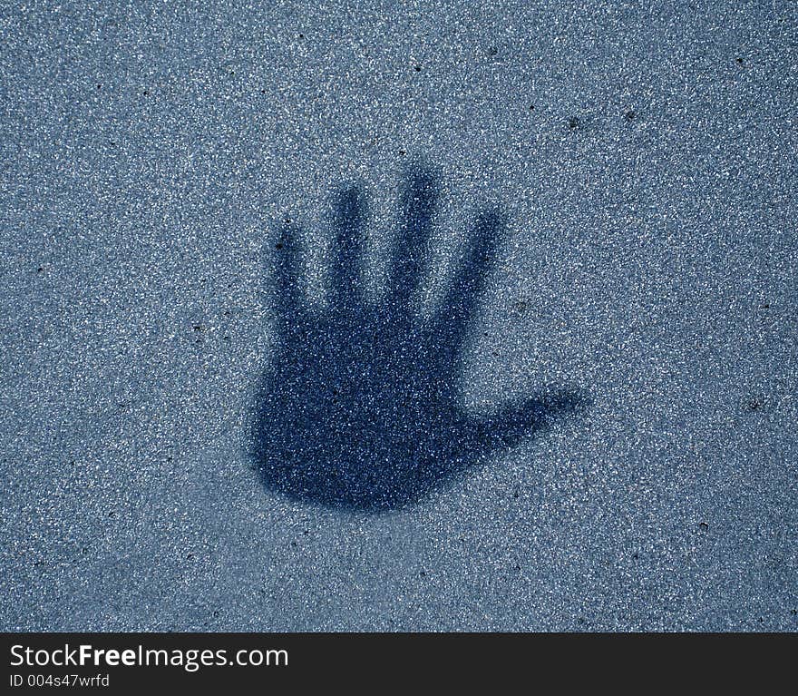 Blue grainy background with a hand print. Blue grainy background with a hand print.