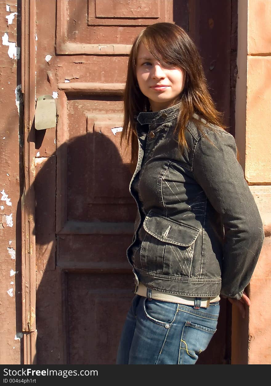 The girl on a background of an old door. The girl on a background of an old door