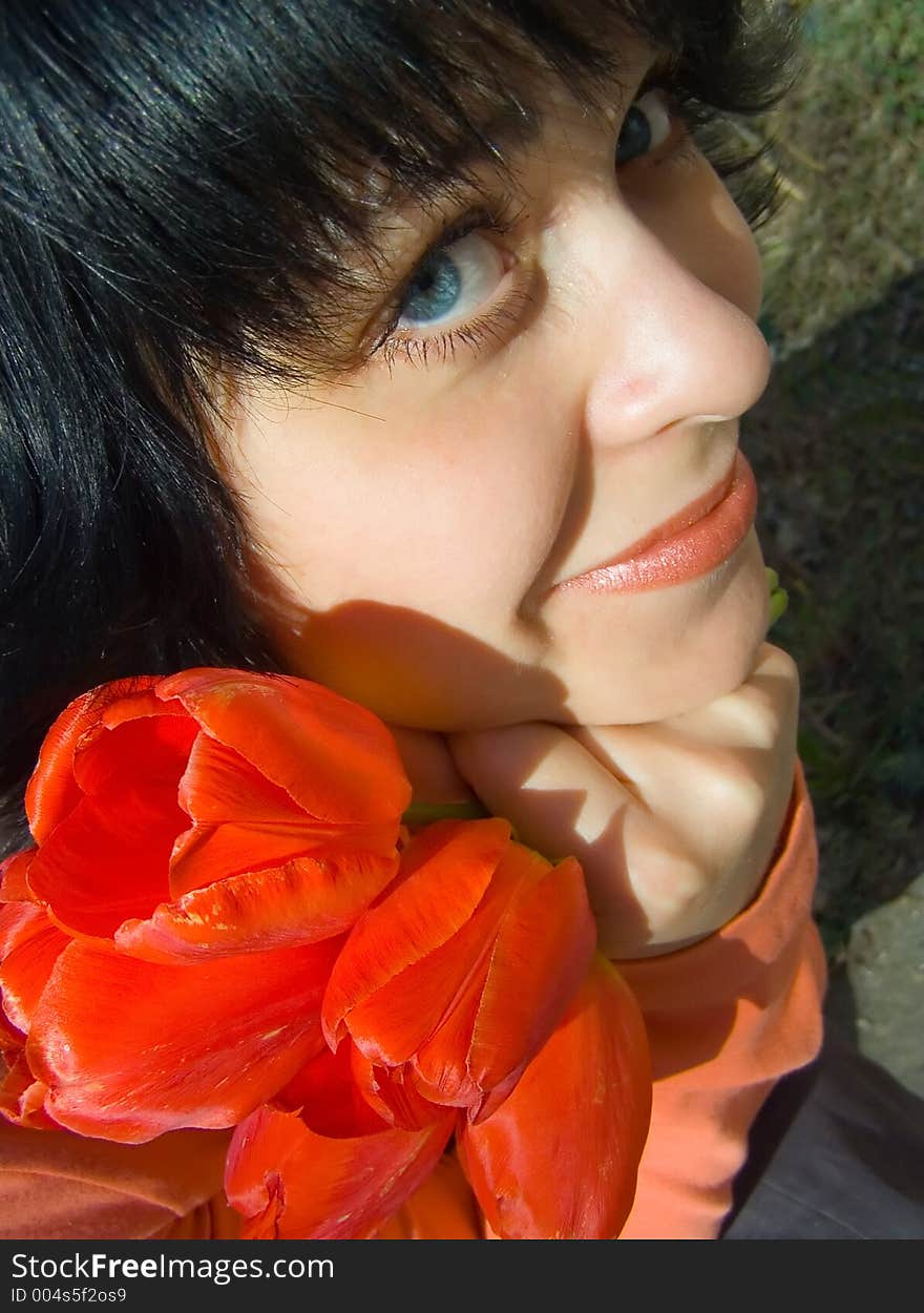 The girl and a bouquet of tulips. The girl and a bouquet of tulips