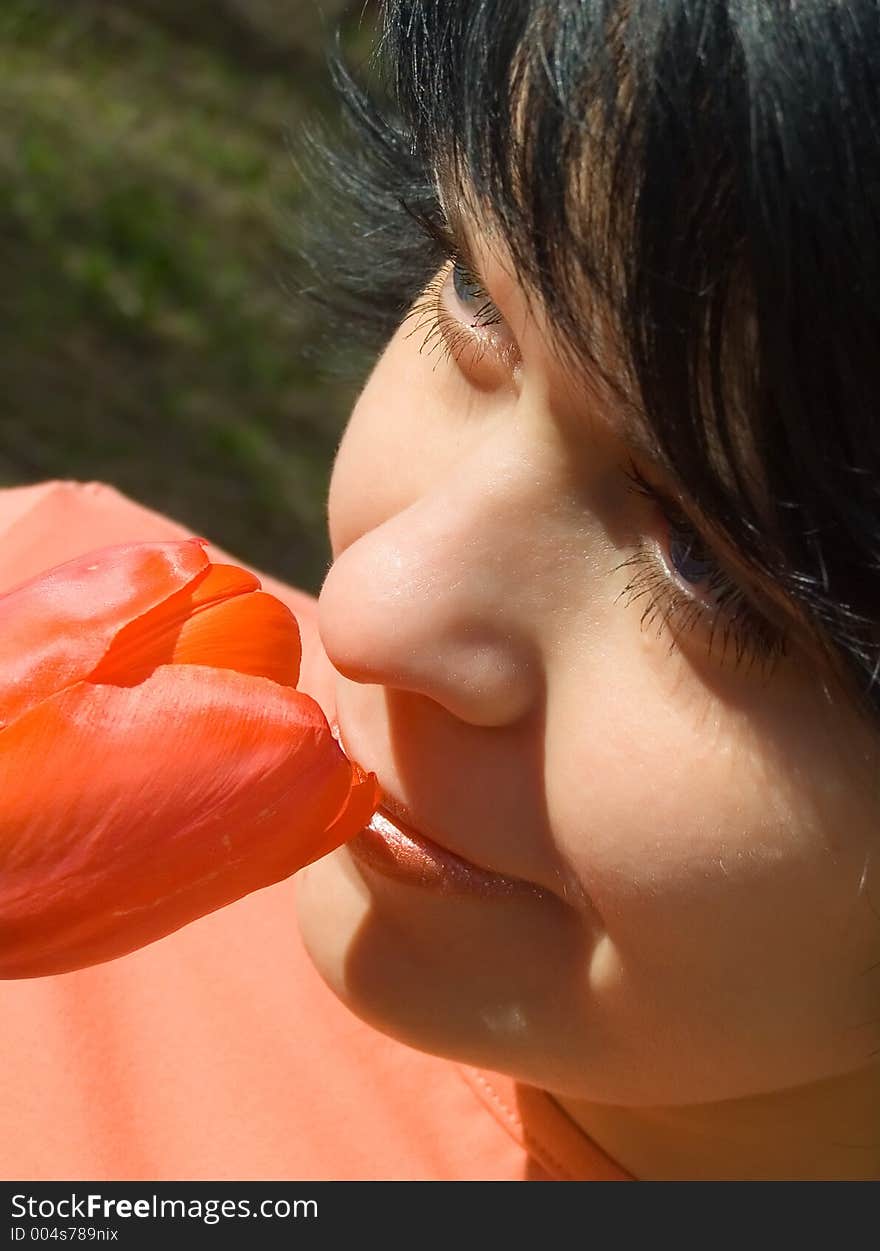 The girl smells a flower