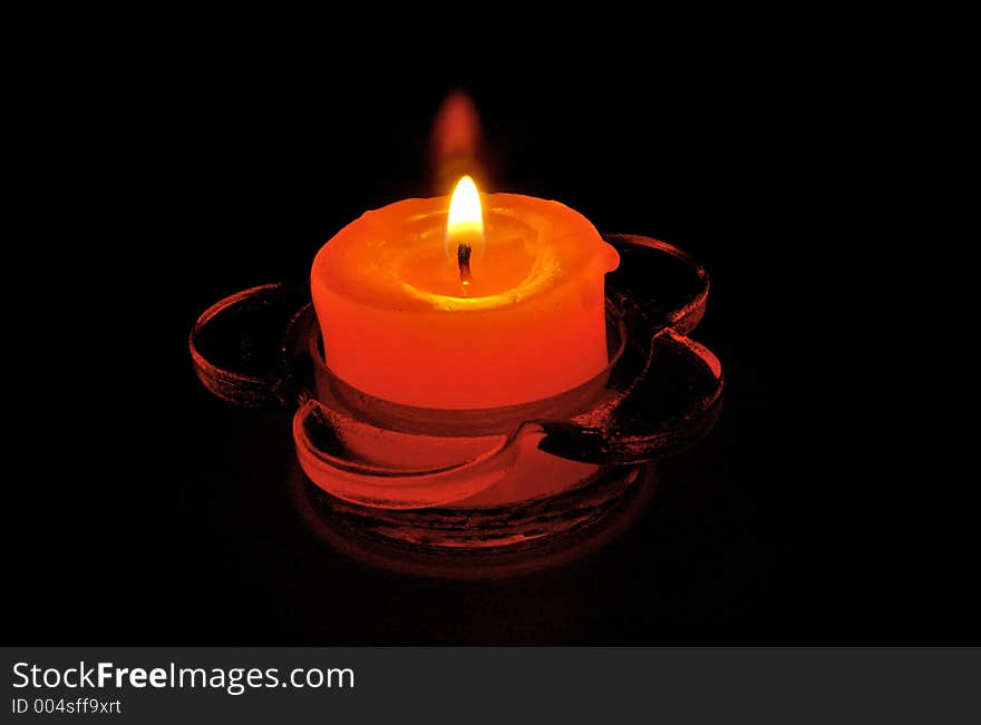 Red candle in glass candelabrum