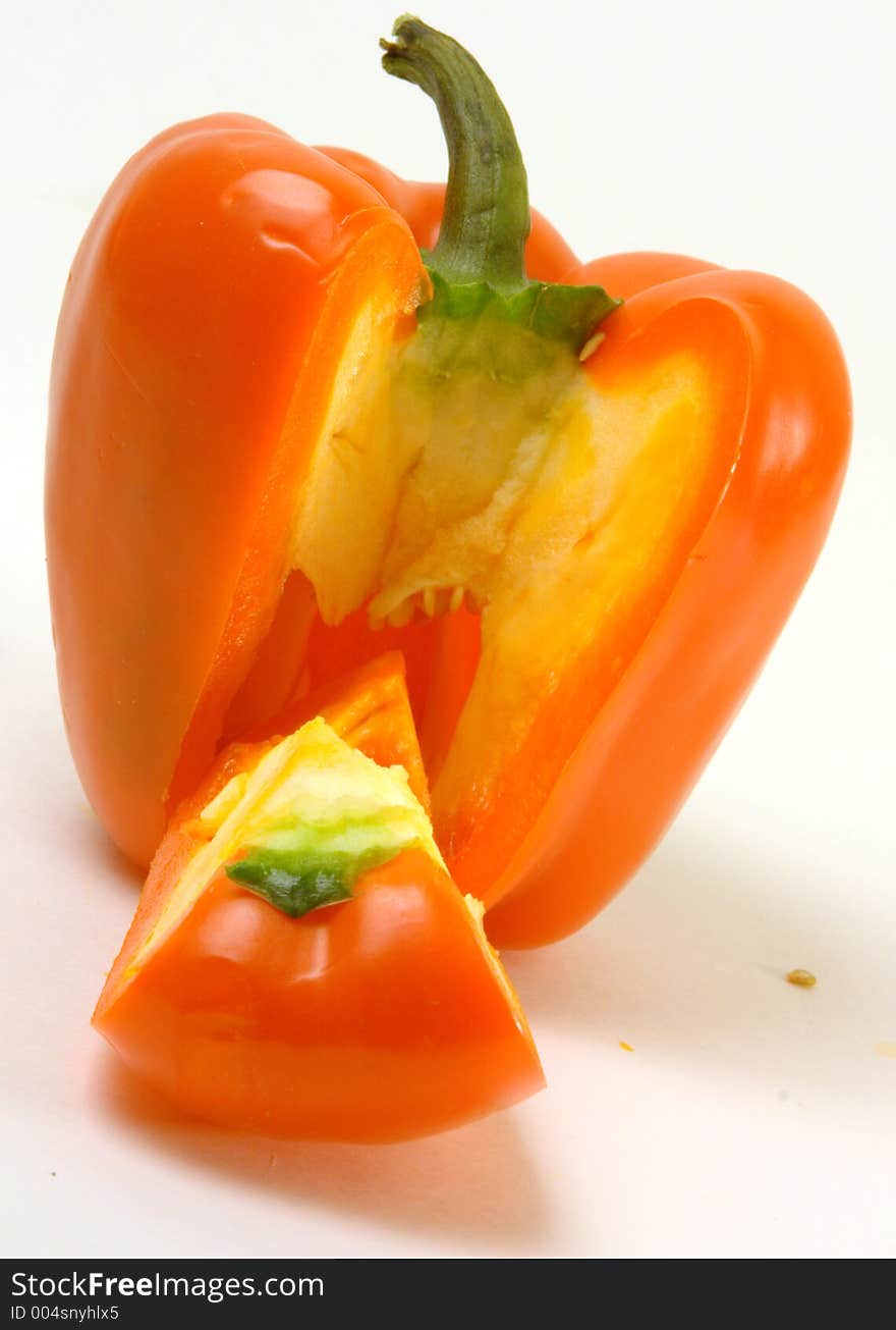 Colorful orange capsicum in front of a white background. Colorful orange capsicum in front of a white background