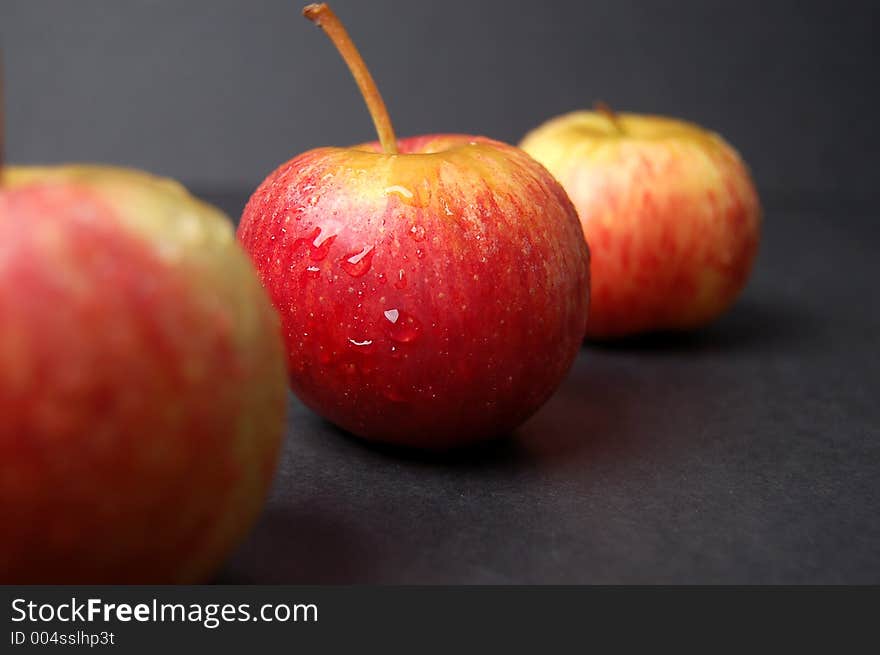 This is an image of an three wet apples. (Please let me know where the image will be used by leaving a message in the Comments Section/See Portfolio). This is an image of an three wet apples. (Please let me know where the image will be used by leaving a message in the Comments Section/See Portfolio)