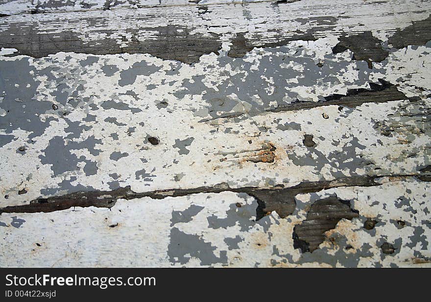 Close up of a wooden bench that sits on the front porch of a historical home. Peeling, crazed, crackled paint. Close up of a wooden bench that sits on the front porch of a historical home. Peeling, crazed, crackled paint.