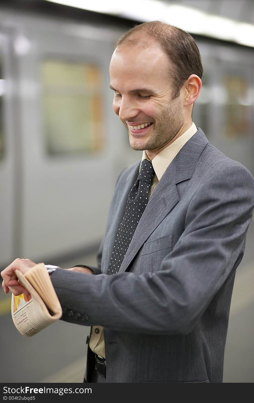 Businessman in front of a train watching his clock. Businessman in front of a train watching his clock