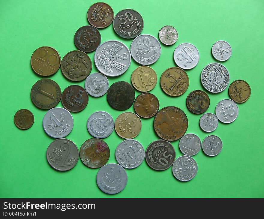 Many difference old coins on green background... obverse side Polish,German,Hungarian,Austrian,Czech&Slovakia,Russian(CCCP),Dutch coins. Many difference old coins on green background... obverse side Polish,German,Hungarian,Austrian,Czech&Slovakia,Russian(CCCP),Dutch coins