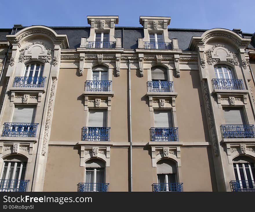 House facade in France in front of blue sky