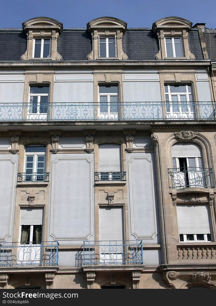 House facade in France in front of blue sky