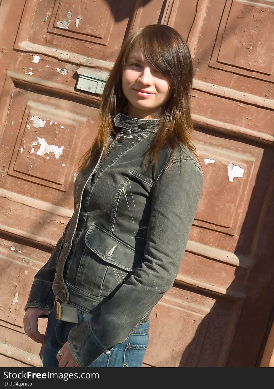 The girl on a background of an old door. The girl on a background of an old door