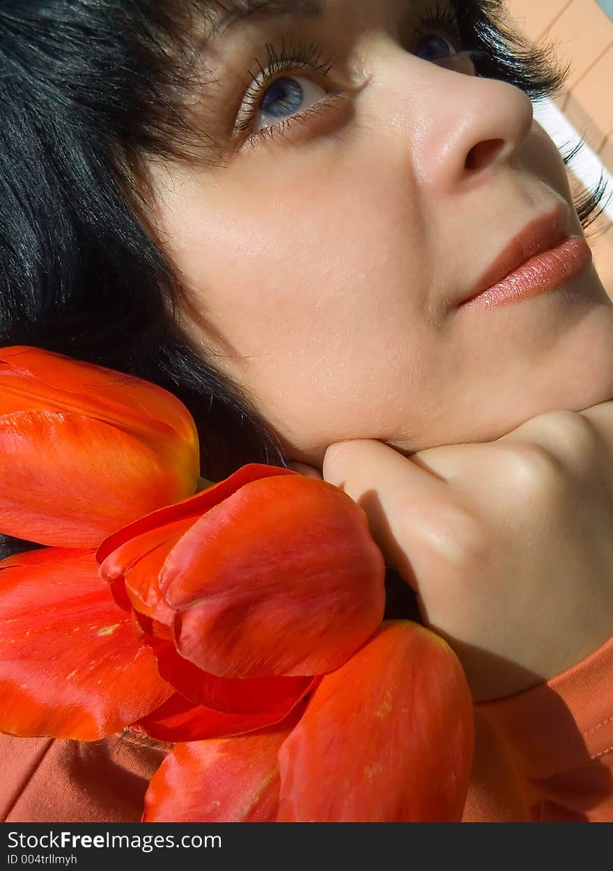 The girl and a bouquet of tulips. The girl and a bouquet of tulips