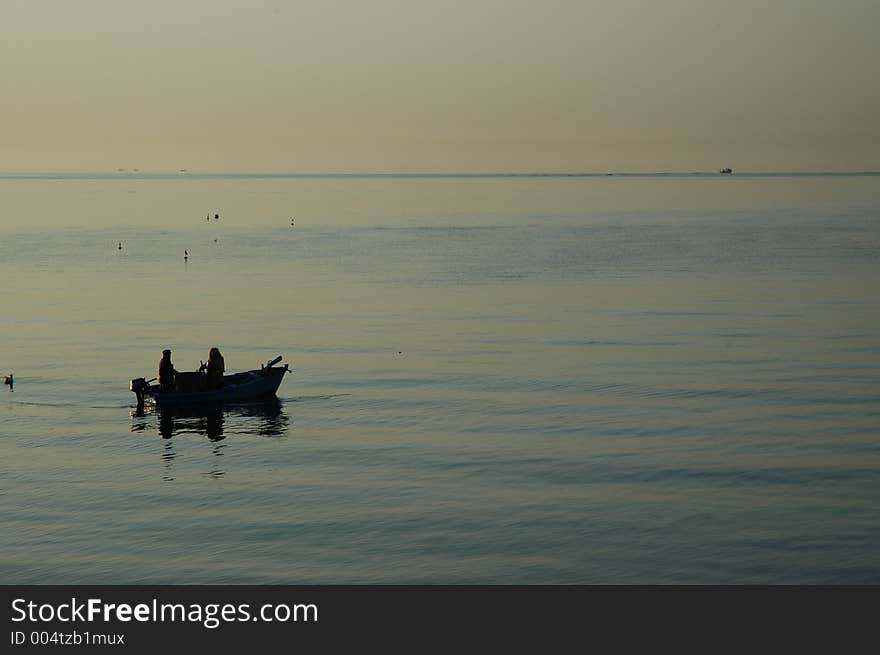 Fishing at sunrise in a bay in manfredonia italy. Fishing at sunrise in a bay in manfredonia italy