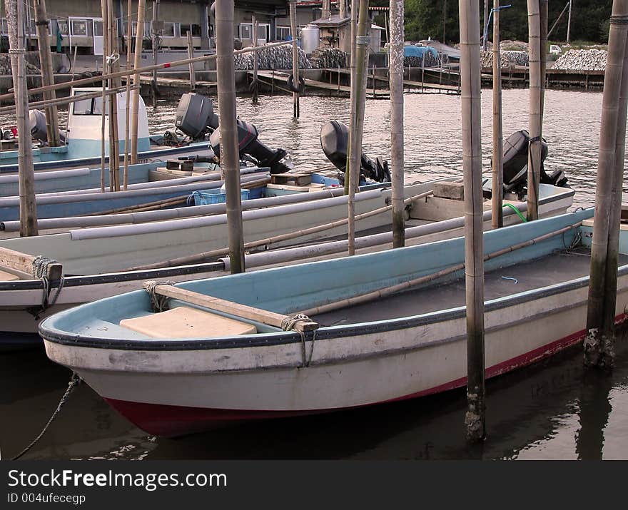 Dusk view with boats in a fishing pier. Dusk view with boats in a fishing pier.