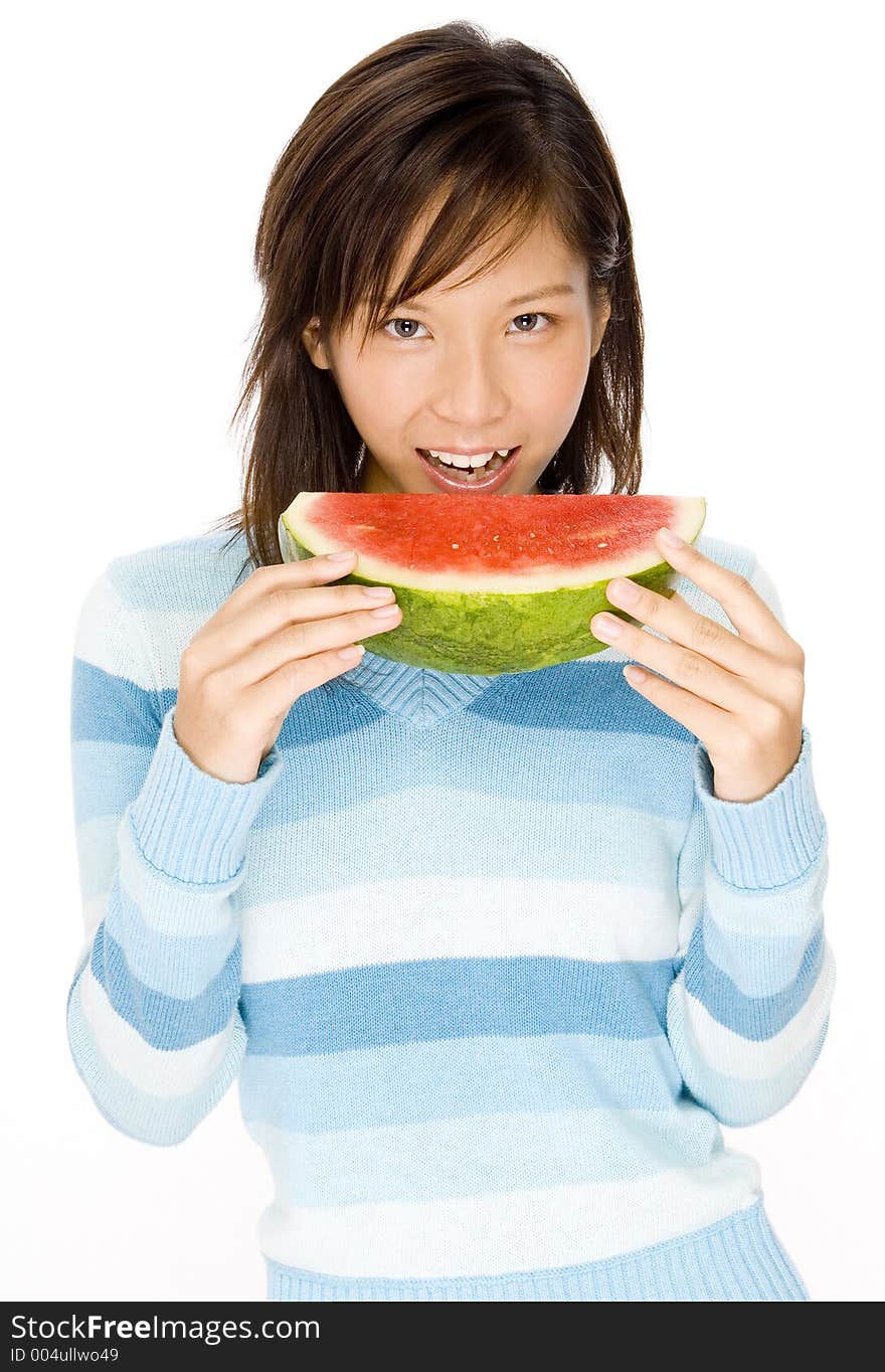 A cute young woman eats a big slice of watermelon. A cute young woman eats a big slice of watermelon