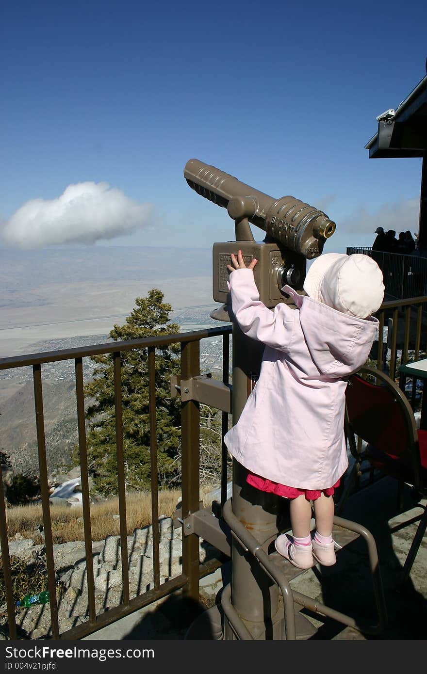 Little girl looking through binoculars. Little girl looking through binoculars