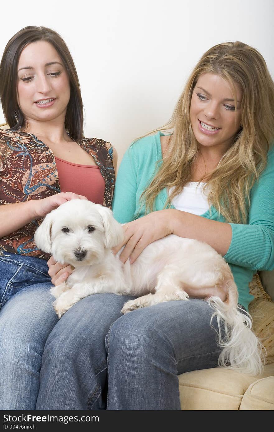 Girlfriends and dog sitting on a couch