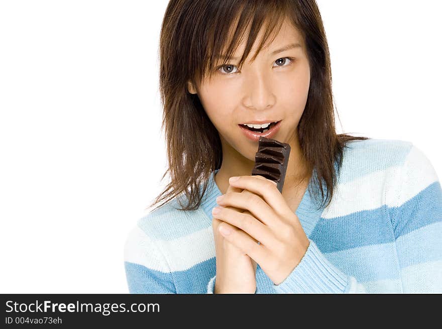 A pretty asian woman gripping a bar of chocolate. A pretty asian woman gripping a bar of chocolate