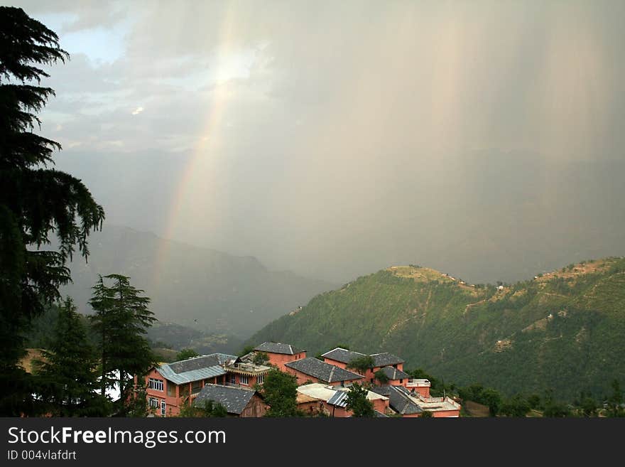 Rainbow and himalayan dwelling in Khajjiar in himalayan India as well as the phenomenon of Virga and dry lightning thunderstorm in the atmosphere. Rainbow and himalayan dwelling in Khajjiar in himalayan India as well as the phenomenon of Virga and dry lightning thunderstorm in the atmosphere