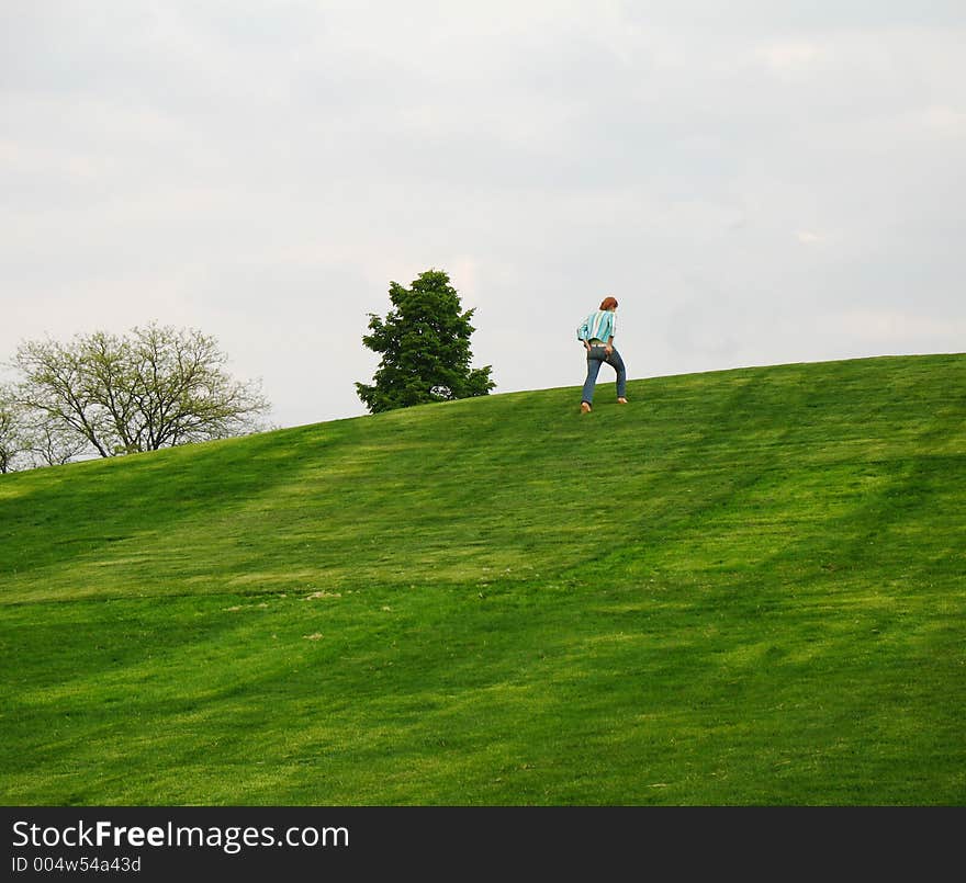 Young fit girl walking up hill