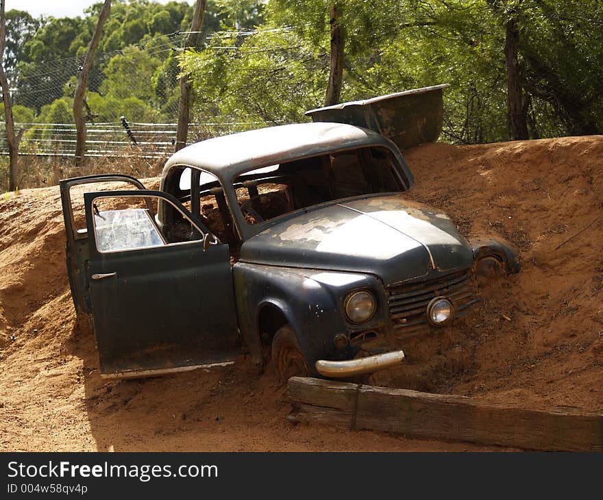 Old pickup half buried. Old pickup half buried