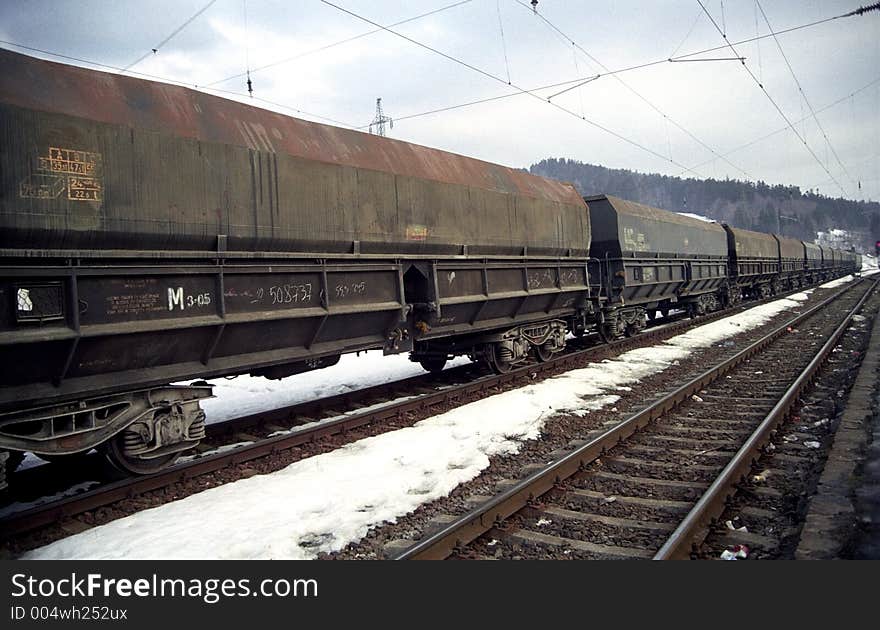 Freight train going towards the horizon parallel to another railroad. 35mm film scan. Freight train going towards the horizon parallel to another railroad. 35mm film scan.