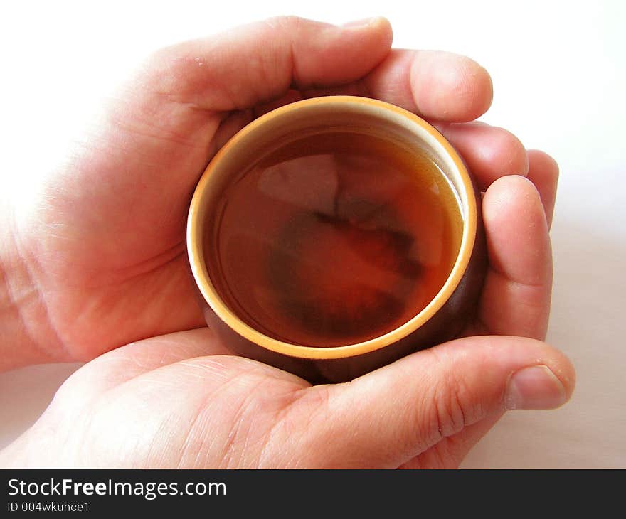 Hands holding an Asian teacup