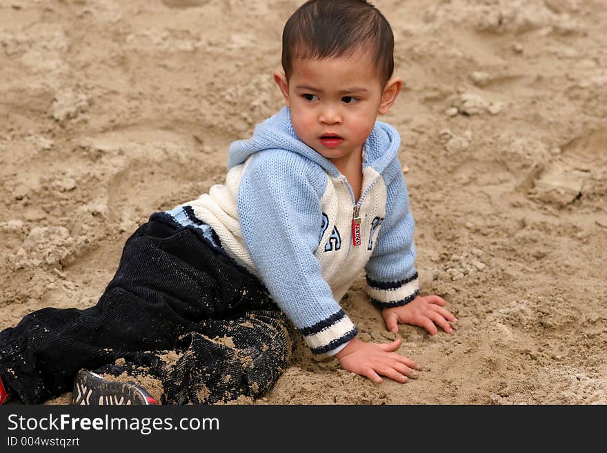 Asian child playing in sand. Asian child playing in sand