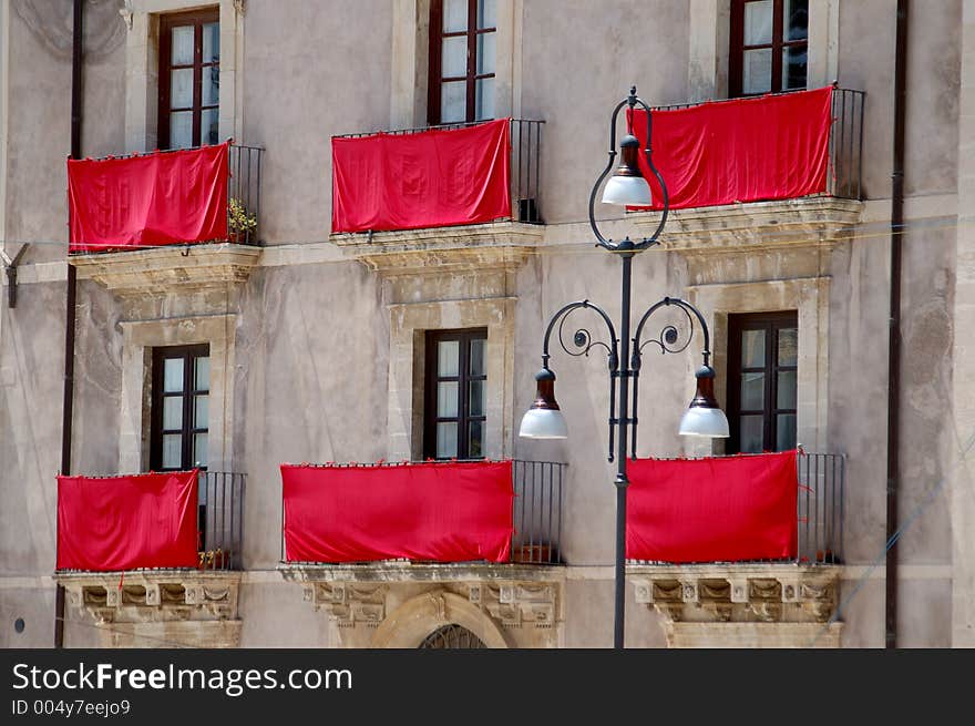 Red drapes on an ancient facade