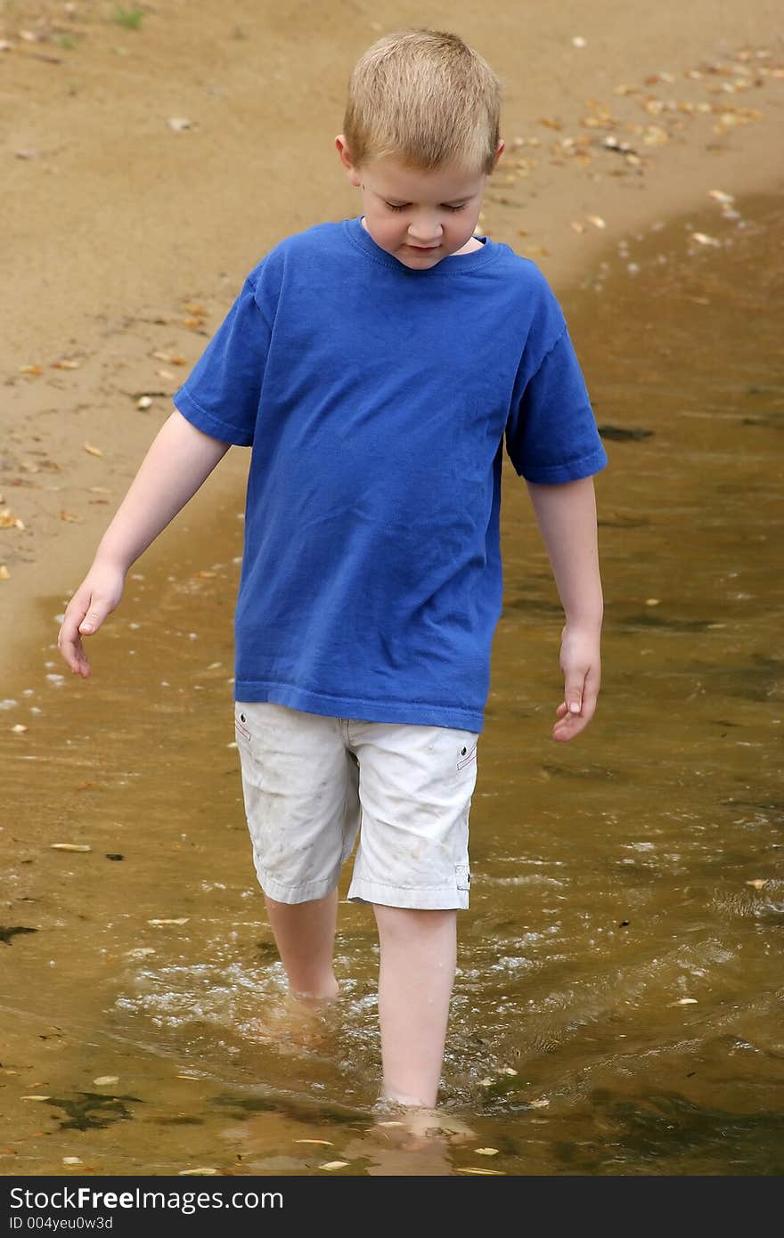 A child wading in a lake.