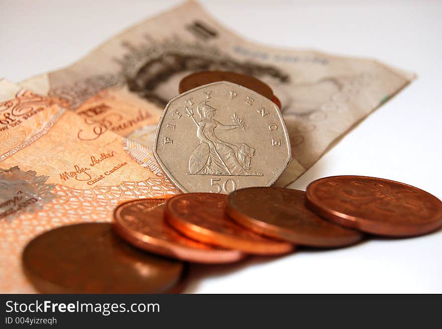 Fifty pence standing tall amongst, coppers and ten pound note. (Please let me know where the image will be used by leaving a message in the Comments Section/See Portfolio). Fifty pence standing tall amongst, coppers and ten pound note. (Please let me know where the image will be used by leaving a message in the Comments Section/See Portfolio)