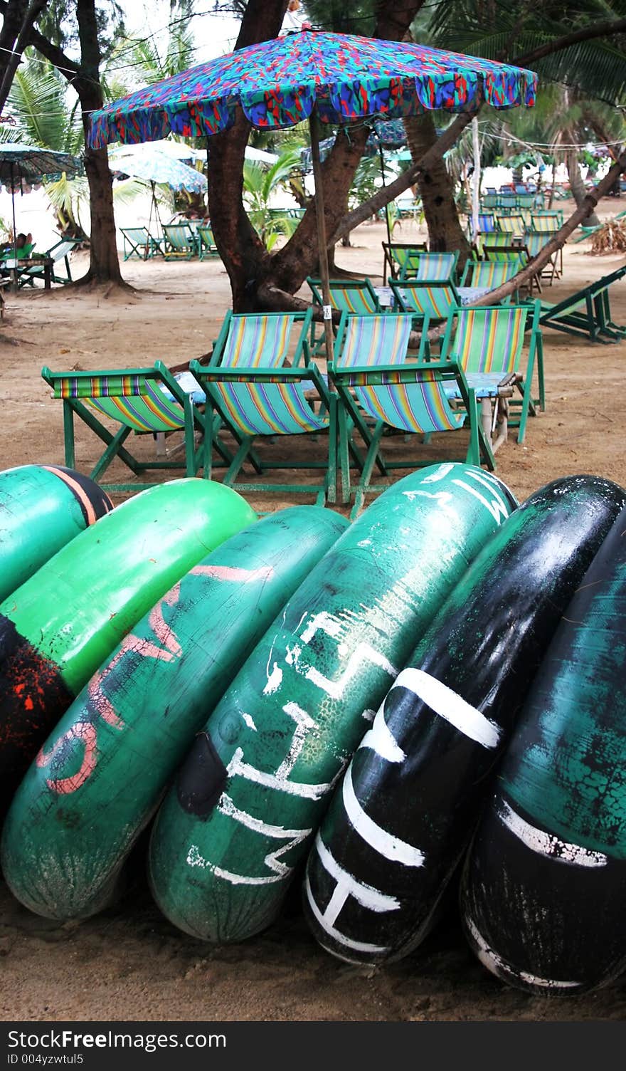 Beach tubes with beach umbrellas in the background. Beach tubes with beach umbrellas in the background