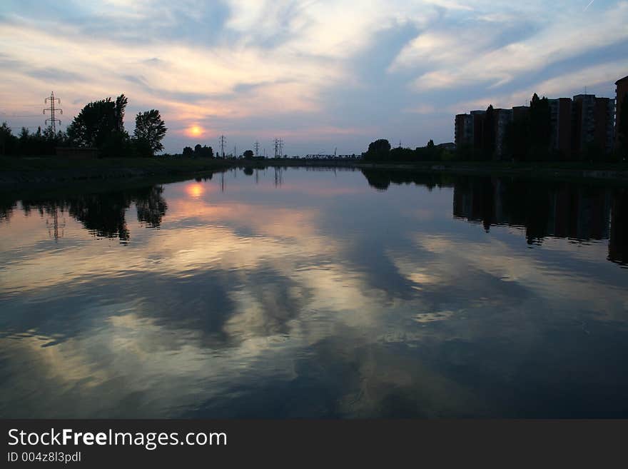 Sunset in the city reflected in the river. Sunset in the city reflected in the river