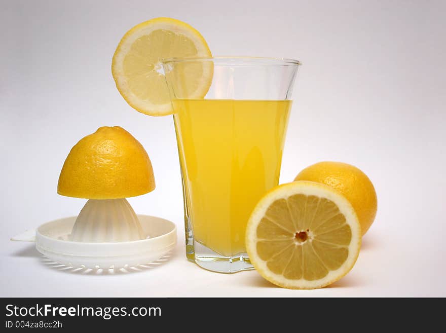 Lemon and lemonade with squeezer in isolated. Lemon and lemonade with squeezer in isolated