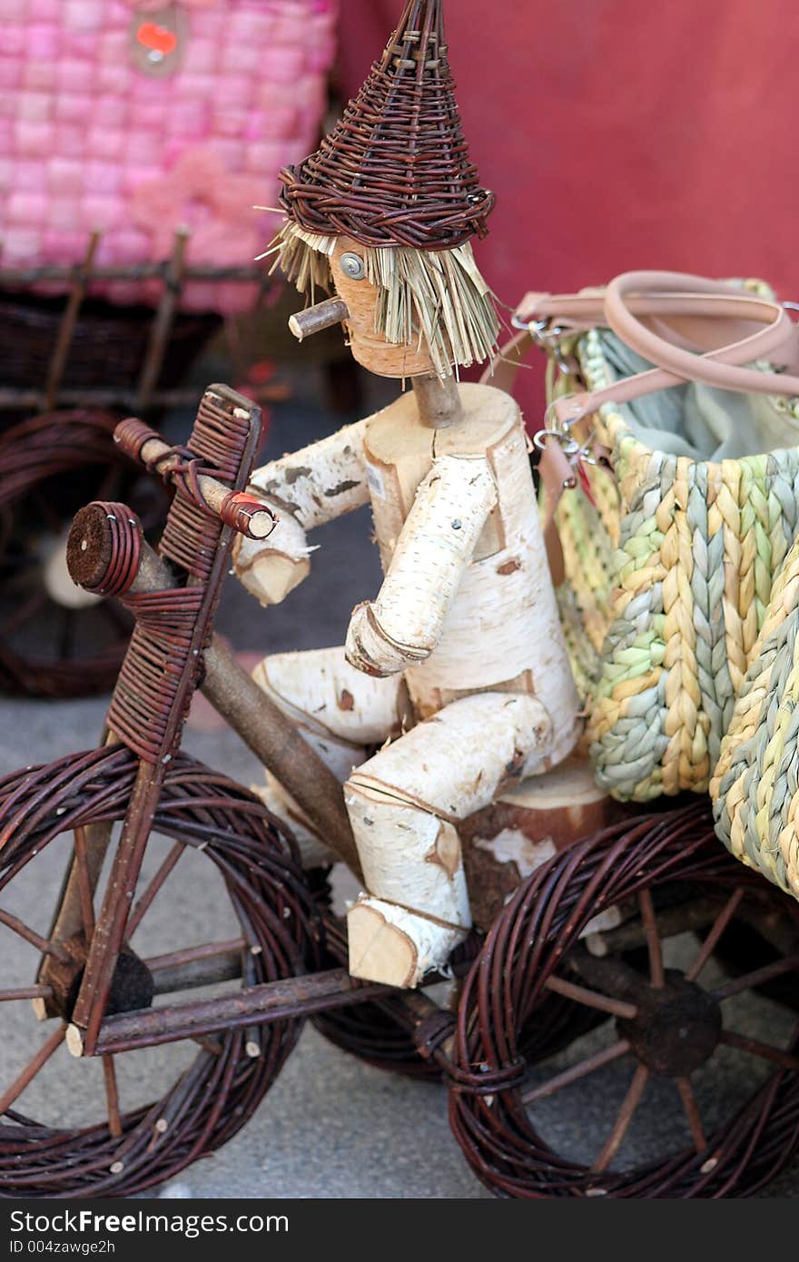 Woody toy with a woody bike at the market