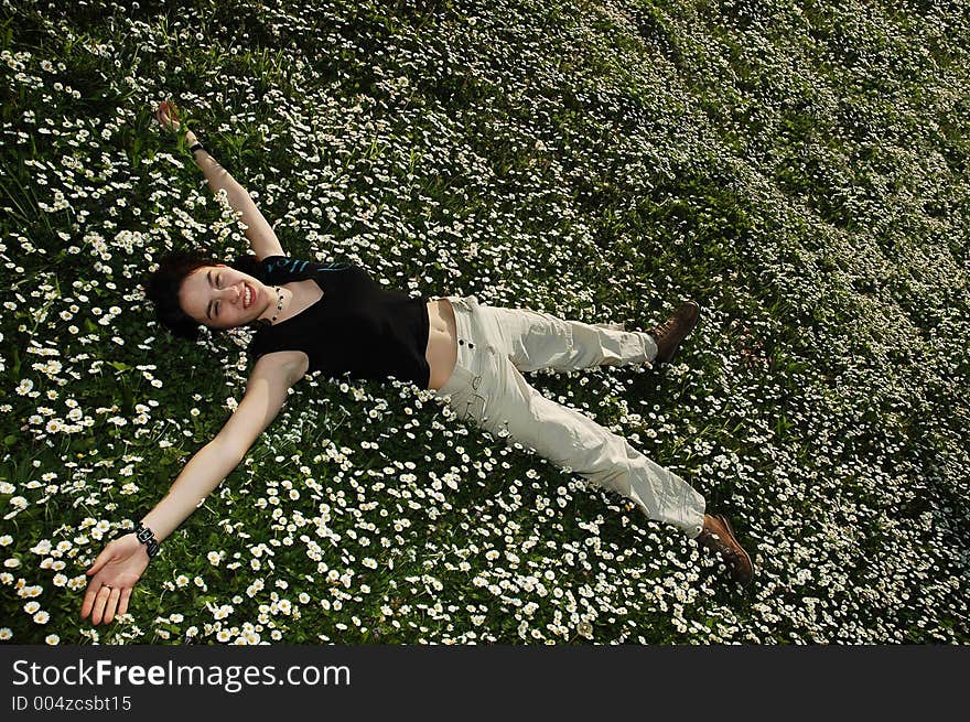 Girl in the flowers with a smile on her face. Girl in the flowers with a smile on her face