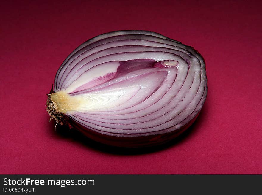 Red onion cut with dark red background