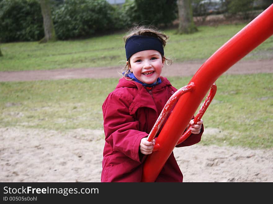 Child on a seesaw going up and down. the seesaw has four arms and the photographer was sitting on one of them - also going up and down. Child on a seesaw going up and down. the seesaw has four arms and the photographer was sitting on one of them - also going up and down.