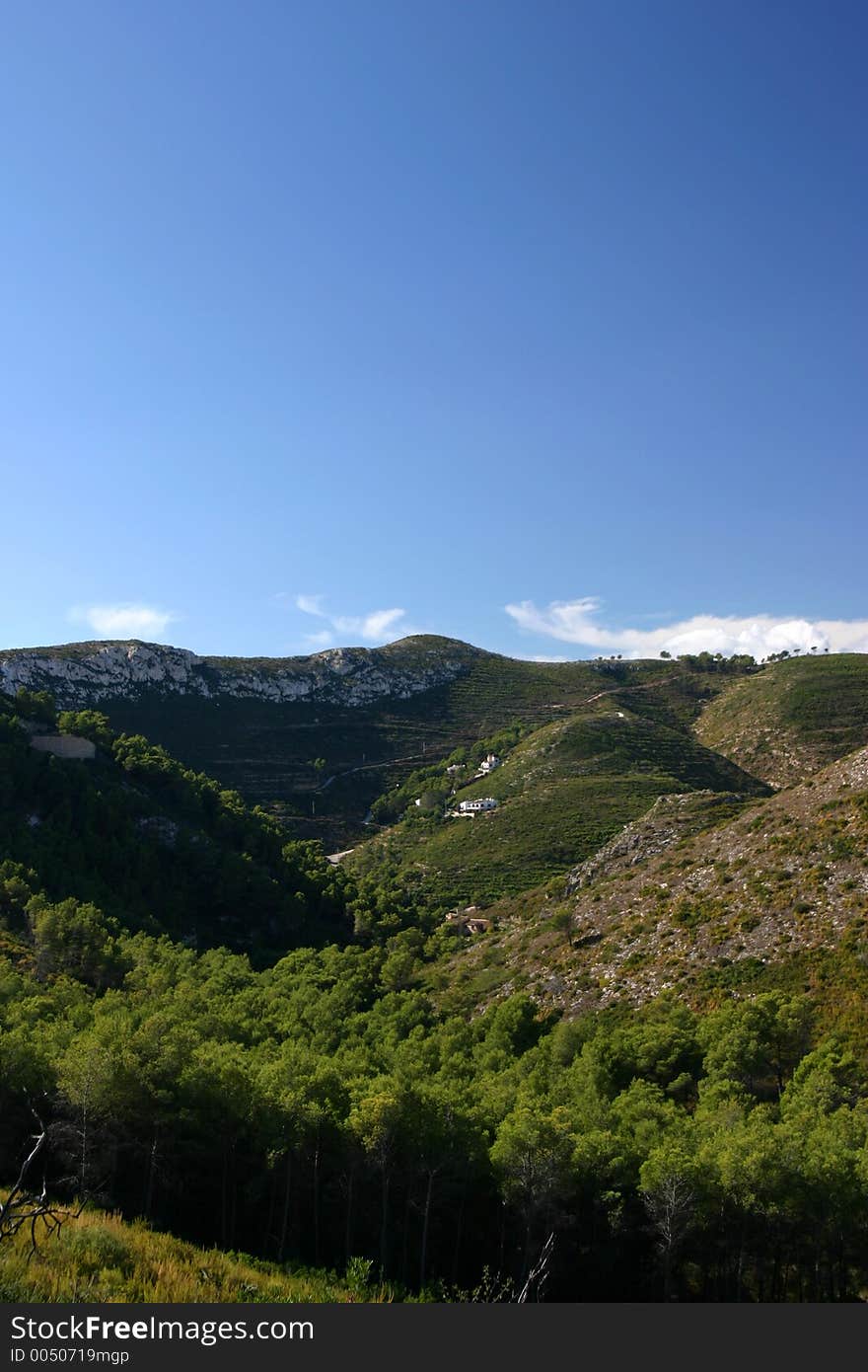 Landscape looking into both lush green valley and the mountains beyond. Landscape looking into both lush green valley and the mountains beyond