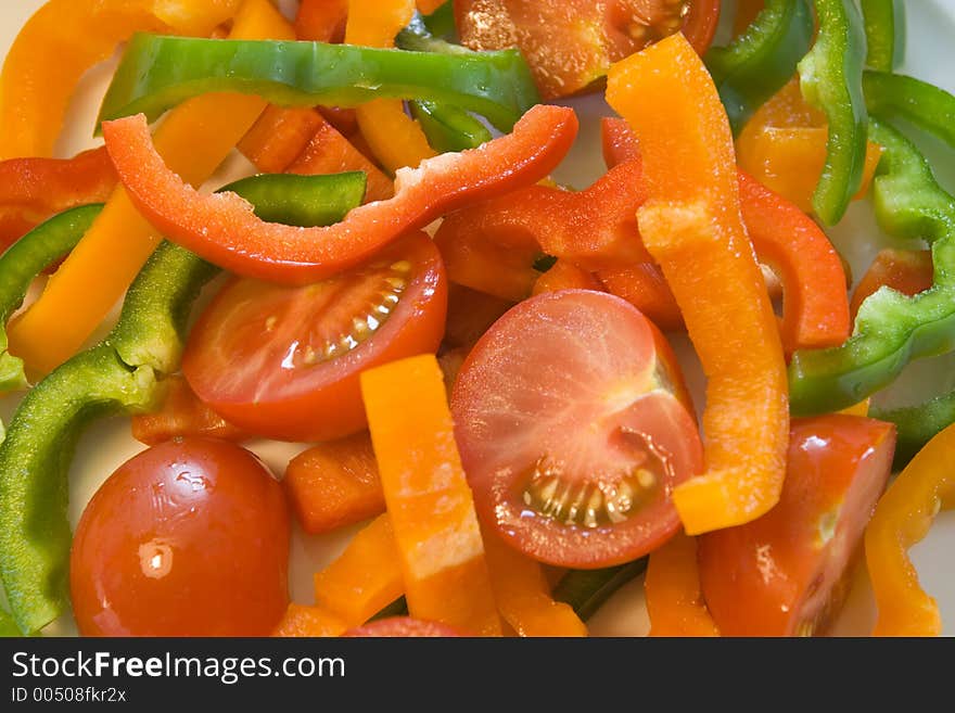 Colorful sliced, tomatoes and bell peppers