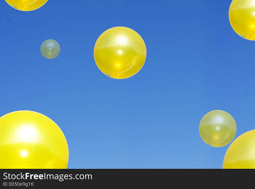 Large Yellow spheres floating in a blue sky. Large Yellow spheres floating in a blue sky