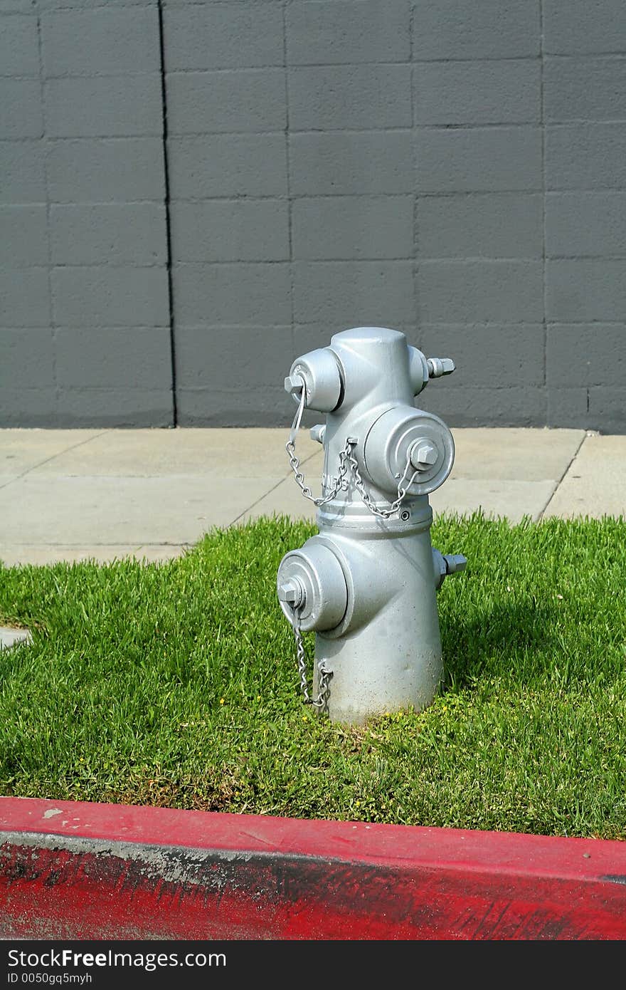 Fire hydrant on the grass on the sidewalk. Fire hydrant on the grass on the sidewalk