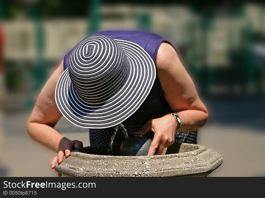 Women drinking water from a fountain. Women drinking water from a fountain.