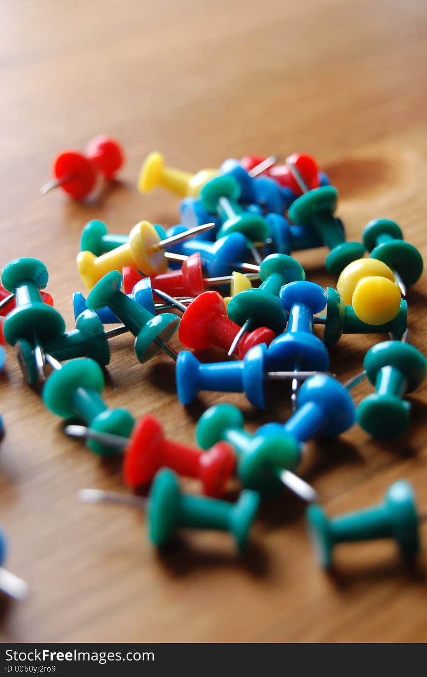 Close up of various Coloured Drawing Pins On Wooden Surface. Close up of various Coloured Drawing Pins On Wooden Surface