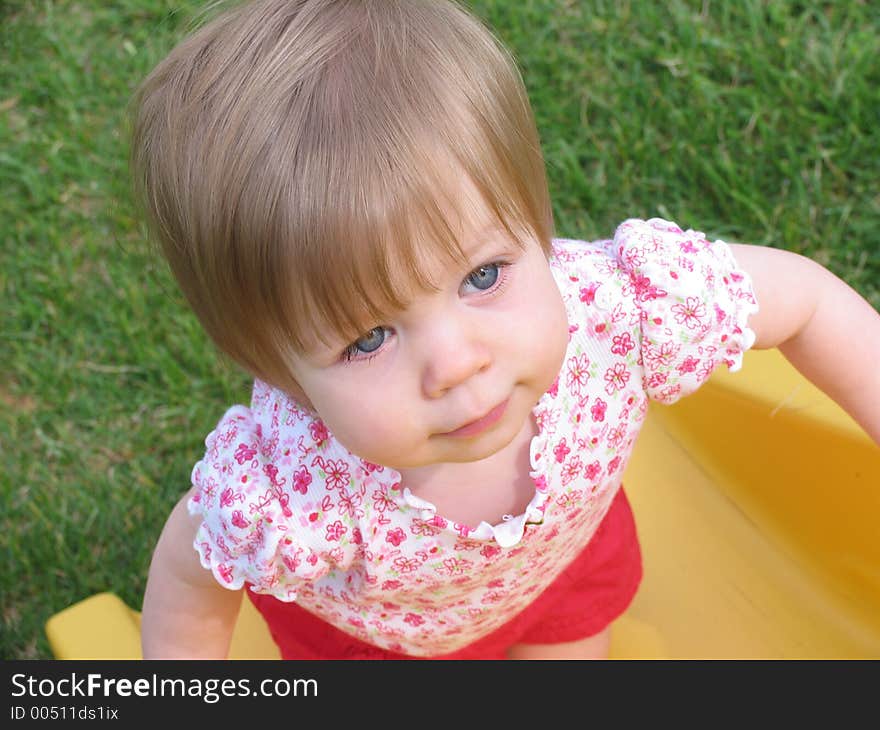 My daughter playing on the slide outside in the backyard. My daughter playing on the slide outside in the backyard.