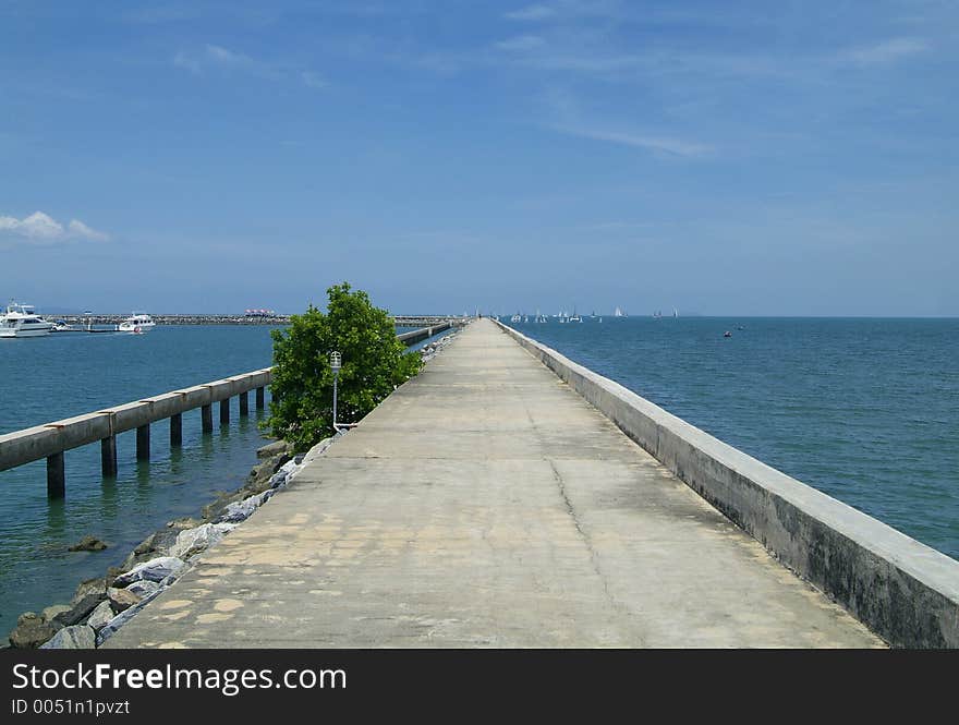 The long cement pier of Ocean Marina in Na Jomtien, Chonburi province, Thailand. The long cement pier of Ocean Marina in Na Jomtien, Chonburi province, Thailand