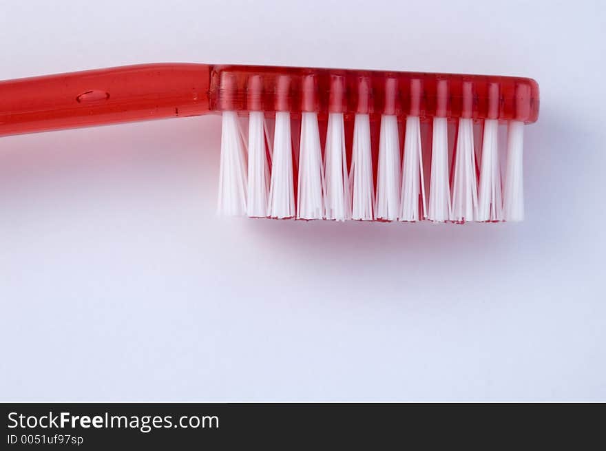 Close-up of red toothbrush against white background