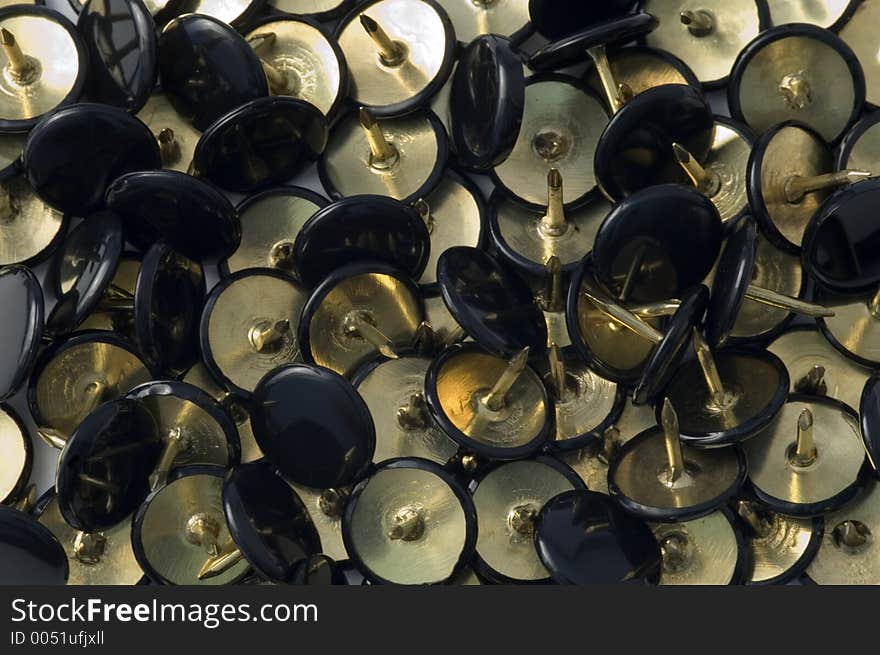 Lots of black & gold thumbtacks