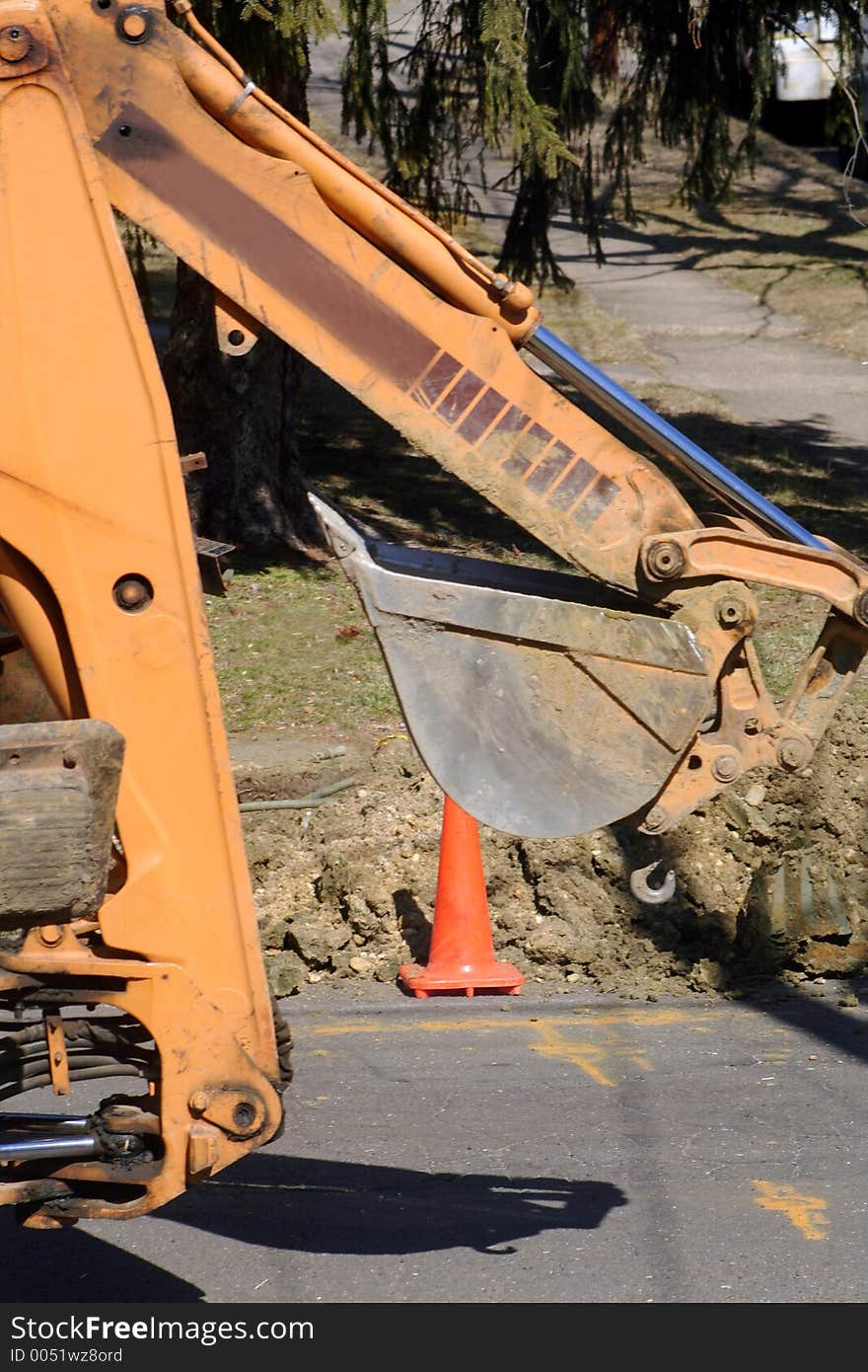 Backhoe parked at construction site.