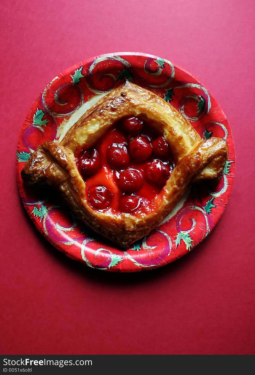 Cherry pastry on a Christmas plate. Cherry pastry on a Christmas plate