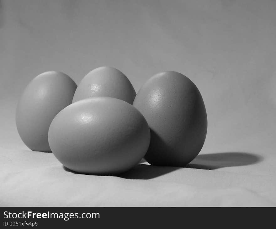 Black and white shot of four eggs. Black and white shot of four eggs.