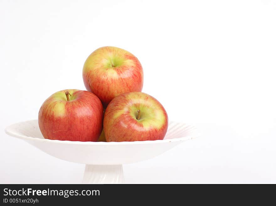 Three apples in a bowl